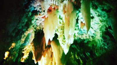 Colorful cave ceiling with stalactites and glowing lights