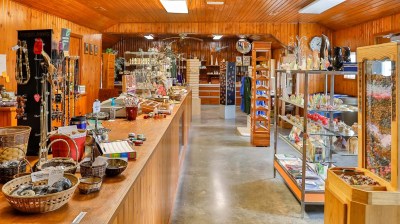 Wood-paneled gift shop with shelves displaying various items and decorations.