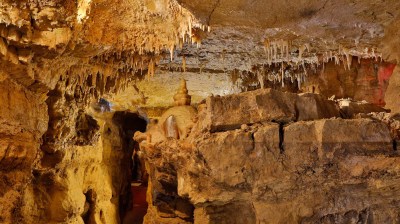 Underground cave with stalactites and rocky formations.