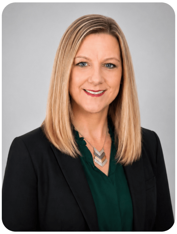 Smiling woman with straight, shoulder-length blonde hair in business attire.